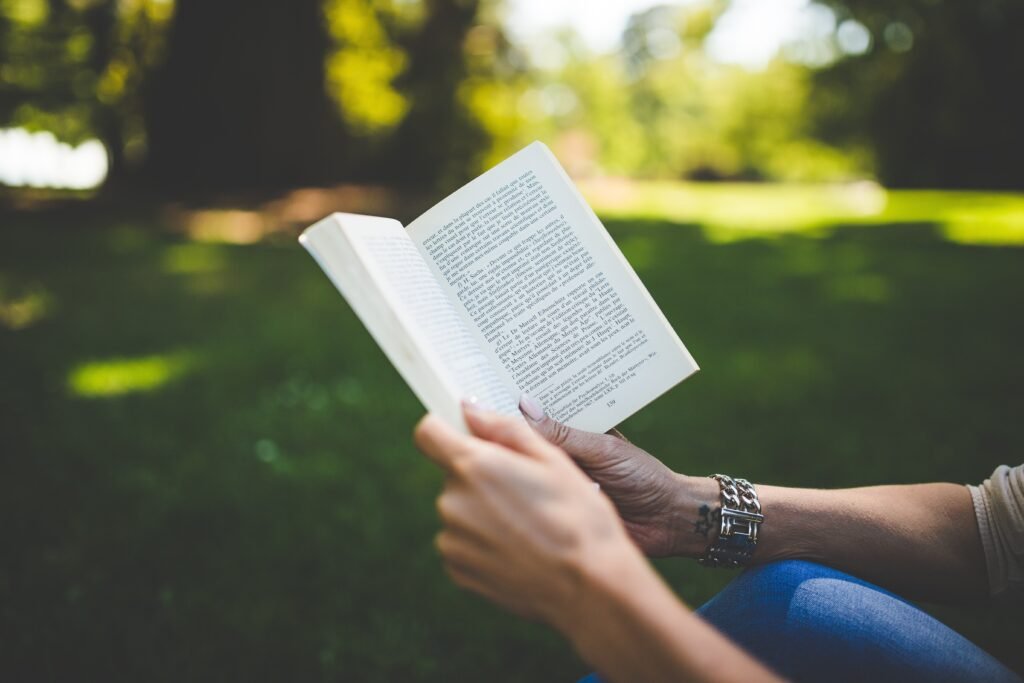A cozy evening scene — person reading a book, dim lights, calm atmosphere. - daily habits of successful people